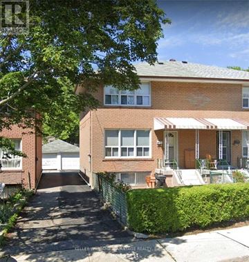 Toronto (Greenwood-Coxwell) apartment for rent - A house with a red brick exterior and a white awning is for sale.