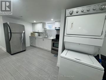 Oshawa (O'neill) apartment for rent - A kitchen with a refrigerator, oven, and microwave.