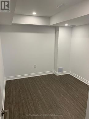 Vaughan (Kleinburg) apartment for rent - A room with wooden flooring and white walls.