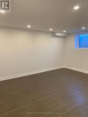 Vaughan (Kleinburg) apartment for rent - A room with wooden flooring and white walls.