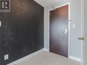 Mississauga (City Centre) condo for rent - A room with a black wall and a brown door.