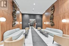 Toronto (Mount Pleasant West) condo for rent - A modern office lobby with a long hallway and seating areas on either side.