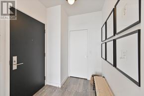 Toronto (Mount Pleasant West) condo for rent - A hallway with a white door and a bench.