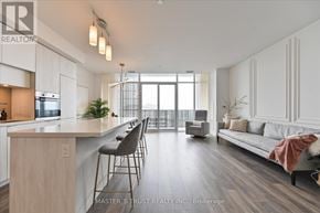 Toronto (Mount Pleasant West) condo for rent - A spacious kitchen and living room with a bar area and a view of the balcony.