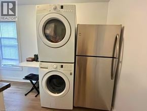Hamilton apartment for rent - A white washing machine and refrigerator in a room.