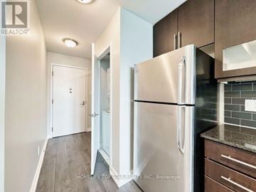 Toronto (Little Portugal) condo for rent - A kitchen with a refrigerator and cabinets.