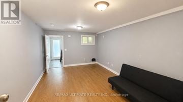 Toronto (Palmerston-Little Italy) apartment for rent - A living room with a black couch and a doorway leading to another room.
