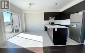 Innisfil (Alcona) apartment for rent - A kitchen with black cabinets and a refrigerator in a real estate listing.