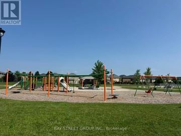 Hamilton (Meadowlands) townhouse for rent - A playground with a slide, swings and climbing frame.