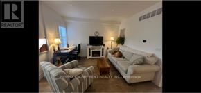 Hamilton (North End) apartment for rent - A living room with a couch, chair, and coffee table.
