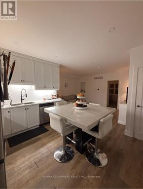 Hamilton (North End) apartment for rent - A modern kitchen with a dining table and chairs.