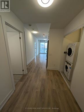 Toronto (Don Valley Village) condo for rent - A long hallway with a washer and dryer in the corner.