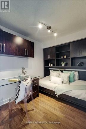 Toronto (Willowdale East) condo for rent - A modern bedroom with a bed, a desk, and a chair.