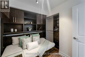 Toronto (Willowdale East) condo for rent - A bedroom with a bed, pillows, and cabinets.