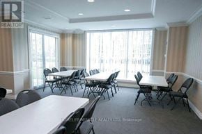 Toronto (Malvern) condo for rent - A conference room with a long table and chairs.