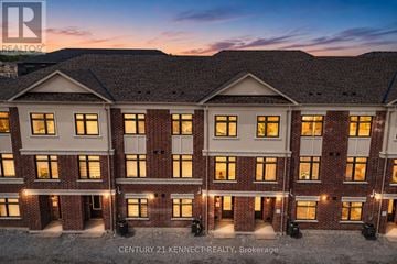Richmond Hill townhouse for rent - A building with the text "CENTURY 21 KENNETH: REALTY, Brokerage" on it.