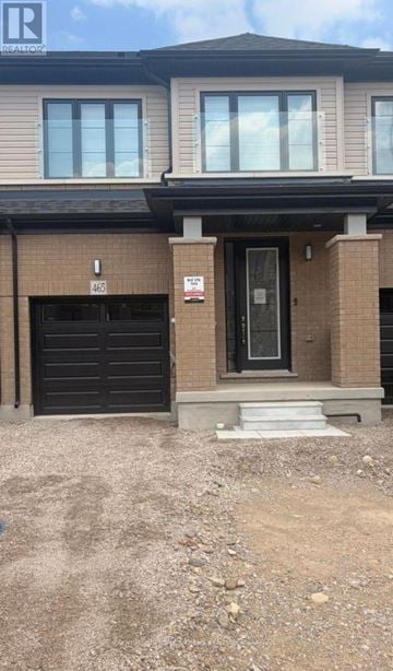 Woodstock (Woodstock - South) townhouse for rent - A house with a black garage door and a white door.