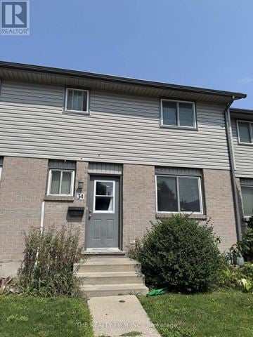 London East (East H) townhouse for rent - A house with a grey front and a blue door.