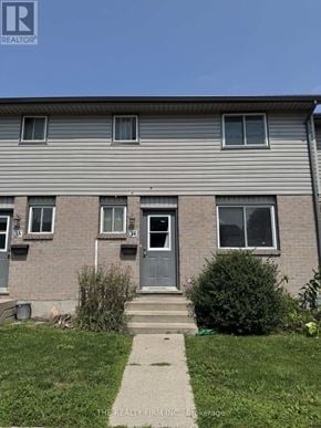 London East (East H) townhouse for rent - A house with a grey facade and a blue door.