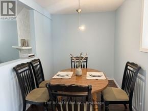 London East (East H) townhouse for rent - A dining room with a table set for two and chairs with a logo on the back of the chairs.