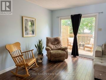London East (East H) townhouse for rent - A living room with a wooden rocking chair and a beige recliner.