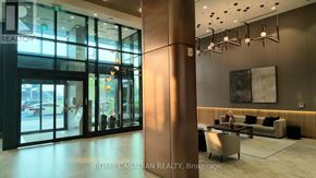 Toronto (York University Heights) condo for rent - A woman is standing in a modern office lobby.