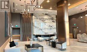 Toronto (York University Heights) condo for rent - A reception area with a marble wall and a large pillar.