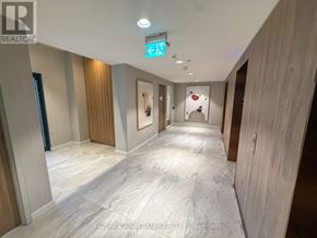 Toronto (York University Heights) condo for rent - A hallway with a green exit sign above the door.