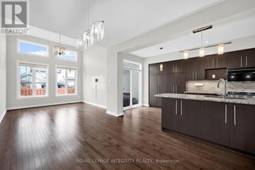 Ottawa townhouse for rent - A spacious kitchen with dark brown cabinets and a large island.