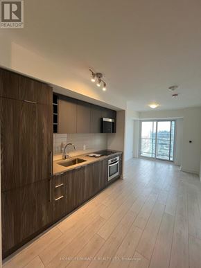 Toronto (Agincourt South-Malvern West) condo for rent - A modern kitchen with wooden cabinets and a large island.