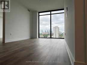 Mississauga (Cooksville) condo for rent - A room with a view of the city skyline through large windows.