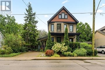 Hamilton (Kirkendall) apartment for rent - A house with a brown roof and a white car parked in front.