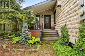 Hamilton (Kirkendall) apartment for rent - A house with a brown door and a small garden in front.
