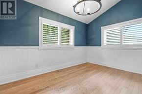 Hamilton (Kirkendall) apartment for rent - A room with blue walls and wooden flooring.