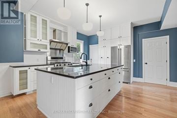 Hamilton (Kirkendall) apartment for rent - A kitchen with white cabinets and a black countertop.