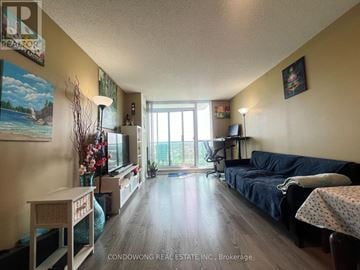 Mississauga (Central Erin Mills) condo for rent - A living room with a blue couch and a wooden table.