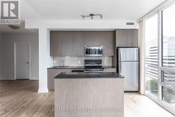 Toronto (Willowdale East) condo for rent - A modern kitchen with a wooden island and stainless steel appliances.
