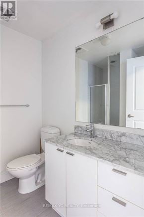 Toronto (Willowdale East) condo for rent - A white bathroom with a marble counter top and a toilet.