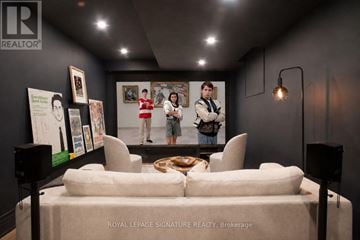 Toronto (University) townhouse for rent - A brokerage office with a white couch and a poster on the wall.