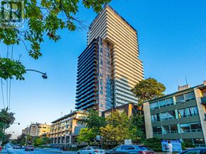 Toronto (Mount Pleasant East) condo for rent - A tall building with a striped facade stands in front of a tree and other buildings.