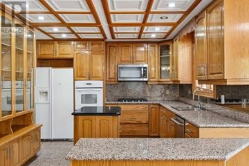 Toronto (Newtonbrook West) apartment for rent - A kitchen with wooden cabinets and a white refrigerator.