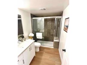 White Rock apartment for rent - A bathroom with a walk in shower and a toilet.