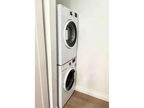 White Rock apartment for rent - A white front loading washing machine in a room.