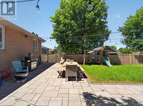 Toronto (Wexford-Maryvale) apartment for rent - A backyard with a patio, a table, chairs, and a swing set.