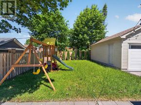 Toronto (Wexford-Maryvale) apartment for rent - A backyard with a wooden swing set and a green slide.