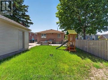 Toronto (Wexford-Maryvale) apartment for rent - A backyard with a playground and a wooden fence.