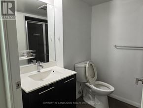 Toronto (Kensington-Chinatown) condo for rent - A white sink in a black and white bathroom.