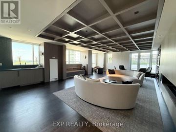 Ottawa condo for rent - A spacious living room with a curved sofa and a large window.