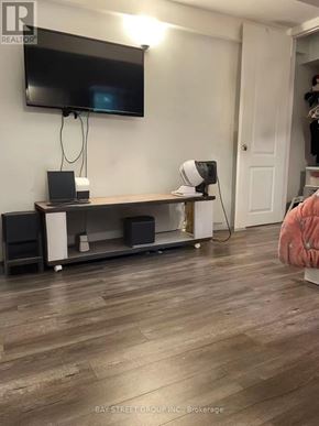 Toronto (Newtonbrook West) apartment for rent - A room with a television, speakers, and a wooden floor.