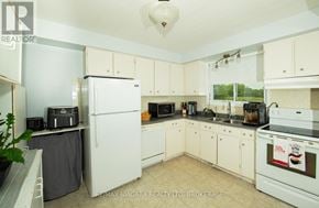 Port Colborne (Main Street) apartment for rent - A kitchen with white appliances and cabinets.